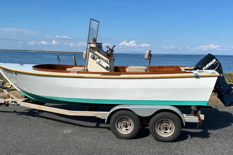 Slide: The Image of Custom Stambaugh Redwing 18' boat on trailer by the sea, 2015 model. - 2