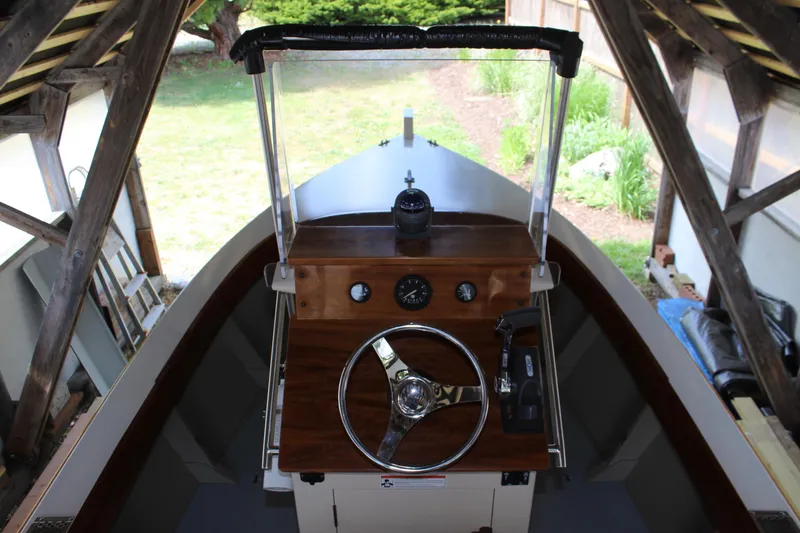 Slide: The Image of 2015 Custom Stambaugh Redwing 18' boat helm with wooden dashboard and steering wheel. - 20