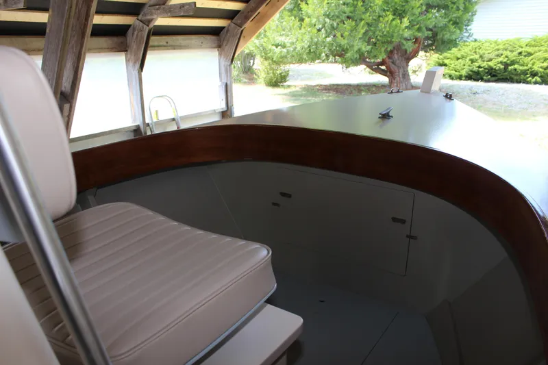 Slide: The Image of Interior of a 2015 Custom Stambaugh Redwing 18' boat with seating and wood accents. - 24