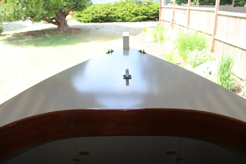 Slide: The Image of Custom Stambaugh Redwing 18' boat, 2015 model, with sleek deck design in a garden setting. - 25
