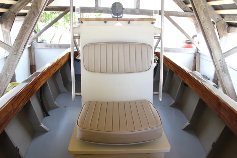 Slide: The Image of Interior of 2015 Custom Stambaugh Redwing 18' boat with beige seating and wooden accents. - 26