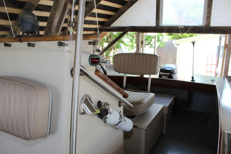Slide: The Image of Interior of a 2015 Custom Stambaugh Redwing 18' boat with seating and equipment. - 27