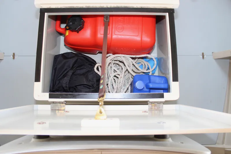 Slide: The Image of Storage compartment with fuel can, rope, and supplies on a 2015 Custom Stambaugh Redwing 18'. - 31