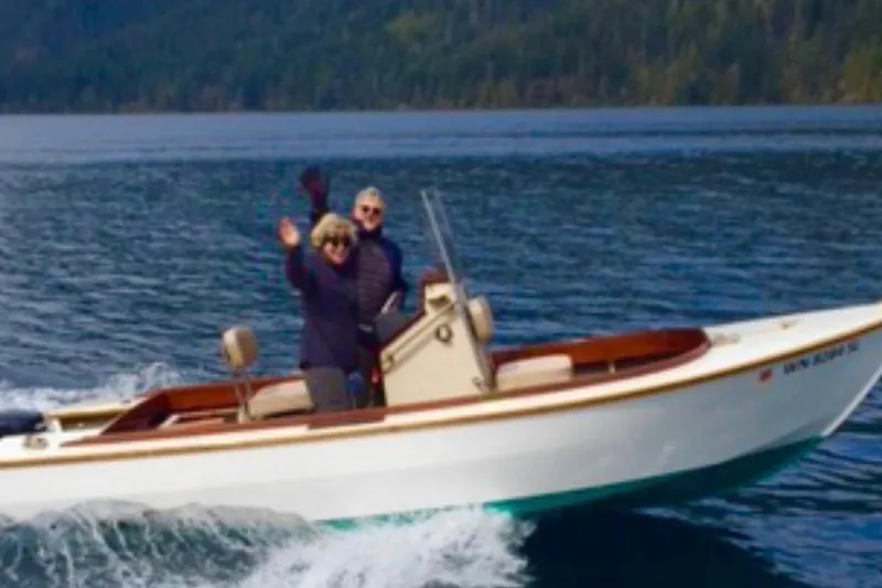 Slide: The Image of Two people enjoying a ride on a 2015 Custom Stambaugh Redwing 18' boat. - 34