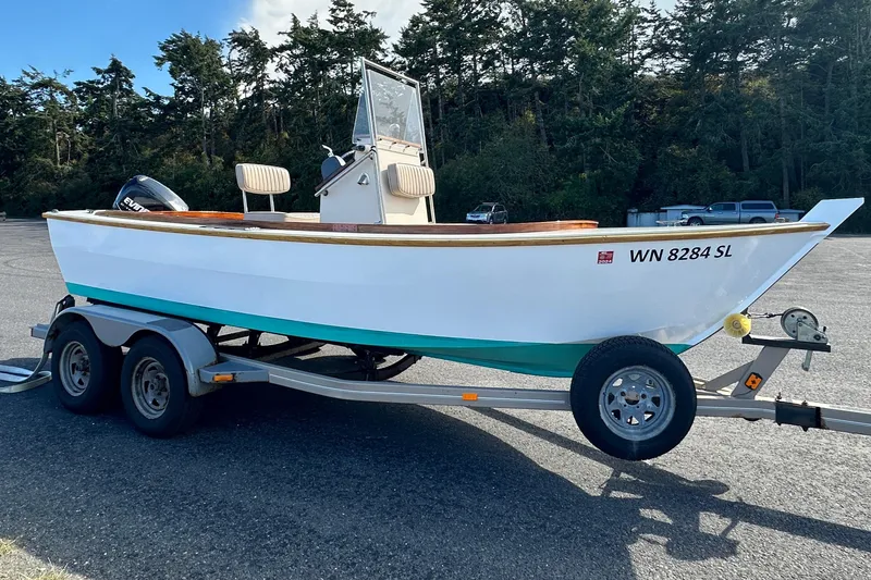 Slide: The Image of Custom 2015 Stambaugh Redwing 18' boat on trailer, parked in a lot with trees in background. - 4