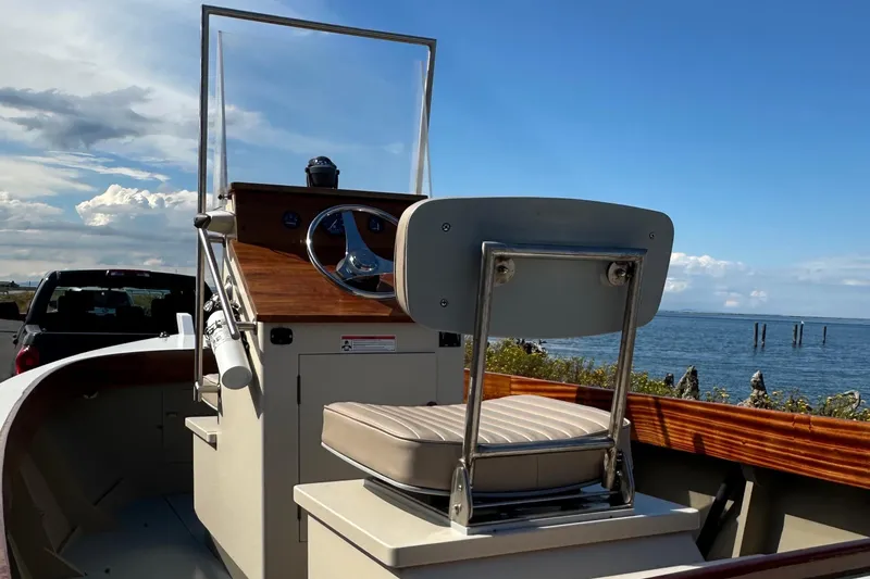 Slide: The Image of Custom Stambaugh Redwing 18' boat, 2015 model, with steering wheel, docked by the sea. - 7