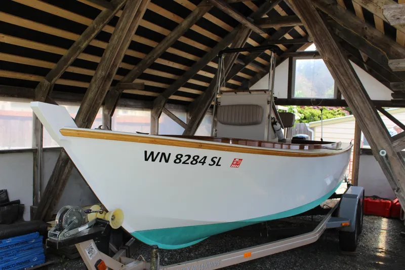Slide: The Image of Custom Stambaugh Redwing 18' boat, 2015 model, on trailer in wooden shelter. - 8