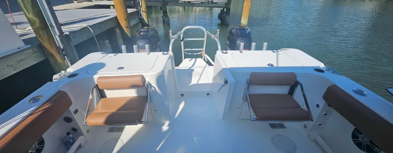 Slide: The Image of 2008 World Cat 320 EC boat interior with seating and water view. - 11