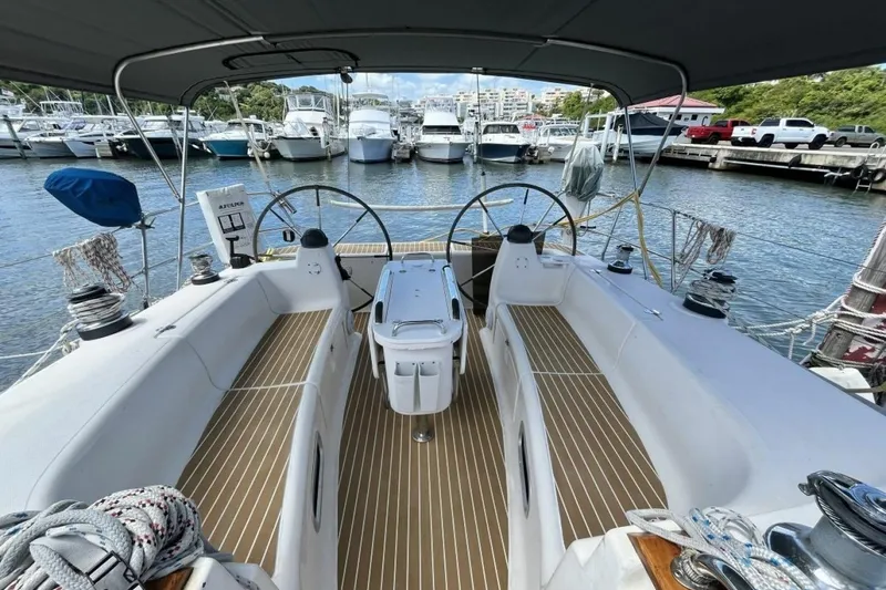 Slide: The Image of Cockpit view of a 2003 Bavaria 44 sailboat docked at a marina. - 12