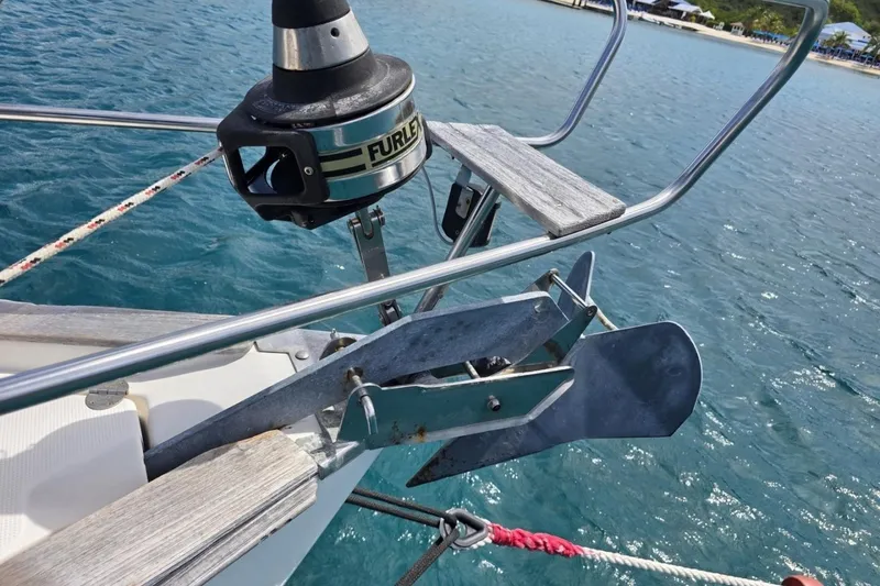 Slide: The Image of Bow of 2003 Bavaria 44 sailboat with anchor and Furlex system in clear blue water. - 17