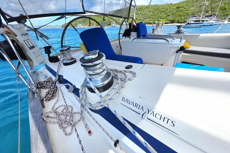Slide: The Image of Sailing yacht Bavaria 44, 2003 model, anchored in a scenic bay with clear blue water. - 19