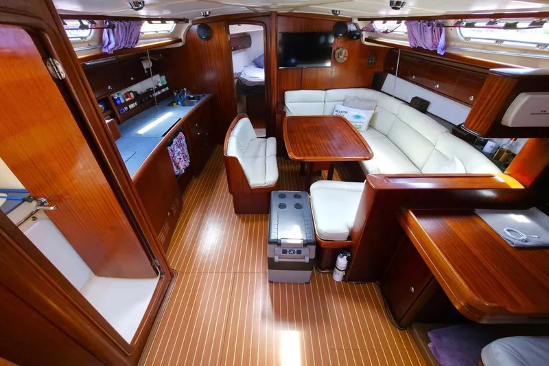 Slide: The Image of Luxurious interior of 2003 Bavaria 44 yacht with wood finish and white seating. - 20