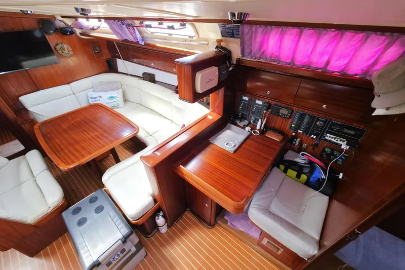 Slide: The Image of Luxurious interior of a 2003 Bavaria 44 yacht with wood finish and comfortable seating. - 21