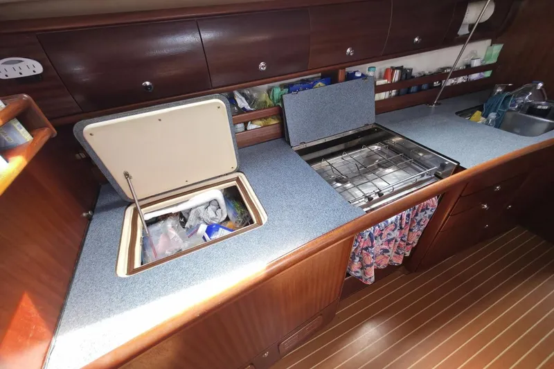Slide: The Image of Galley kitchen in 2003 Bavaria 44 yacht with stove and storage compartments. - 23