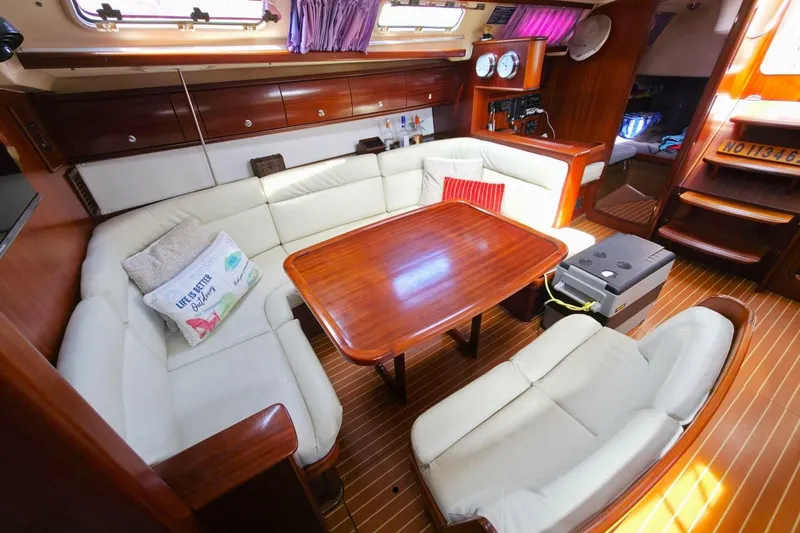 Slide: The Image of Interior of a 2003 Bavaria 44 yacht with cozy seating and wooden table. - 24