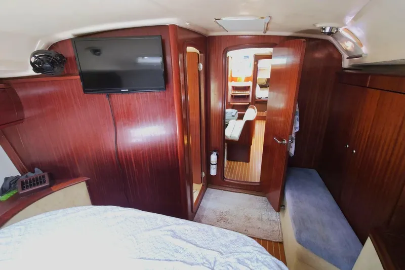 Slide: The Image of Interior of 2003 Bavaria 44 yacht with wood paneling and mounted TV. - 26