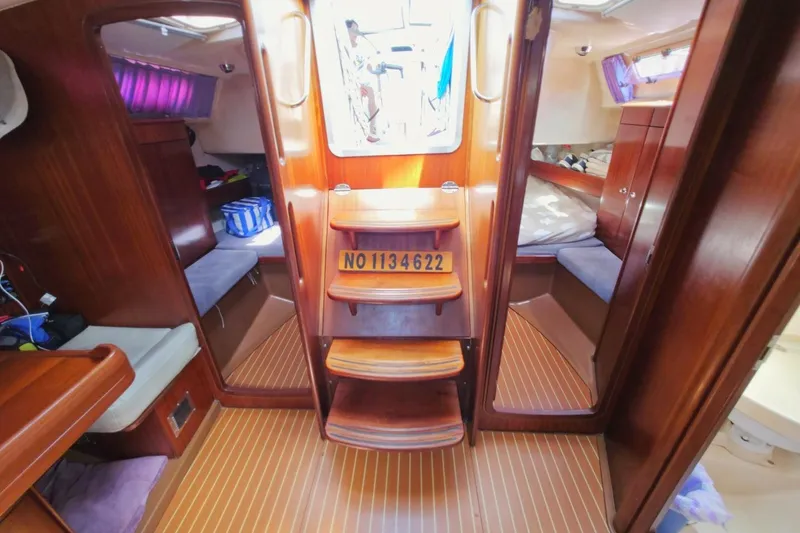 Slide: The Image of Interior of a 2003 Bavaria 44 sailboat with wooden finishes and cozy seating. - 27