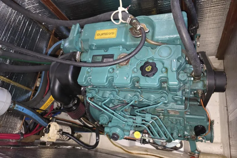 Slide: The Image of Engine compartment of a 2003 Bavaria 44 sailboat, showcasing detailed mechanical components. - 31