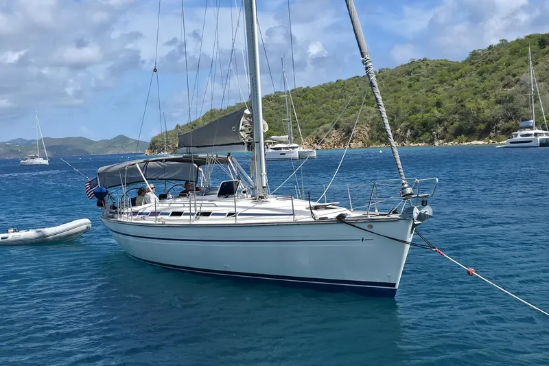 Slide: The Image of Sailing yacht Bavaria 44 (2003) anchored in clear blue waters near lush green islands. - 4