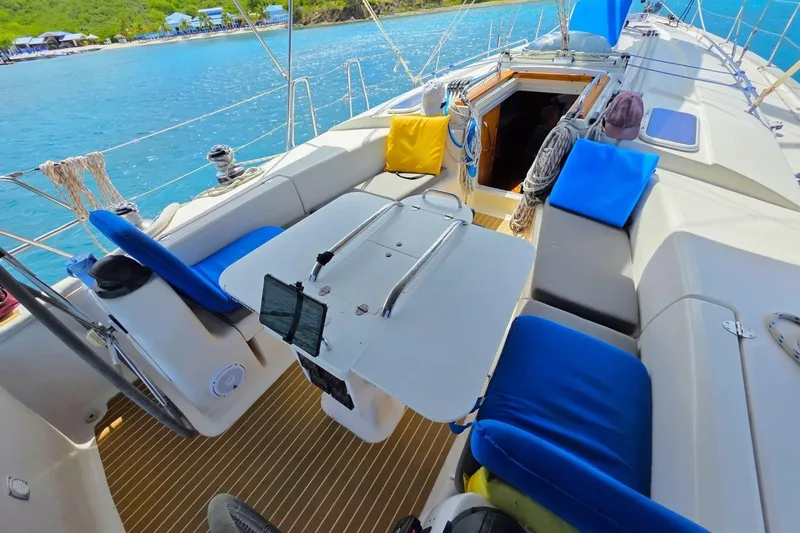 Slide: The Image of Spacious deck of a 2003 Bavaria 44 yacht with blue cushions and scenic ocean view. - 9