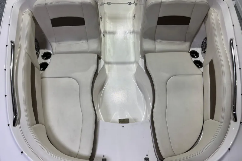 Slide: The Image of Interior seating of 2015 Chaparral 244 Sunesta boat, featuring white cushioned seats. - 10
