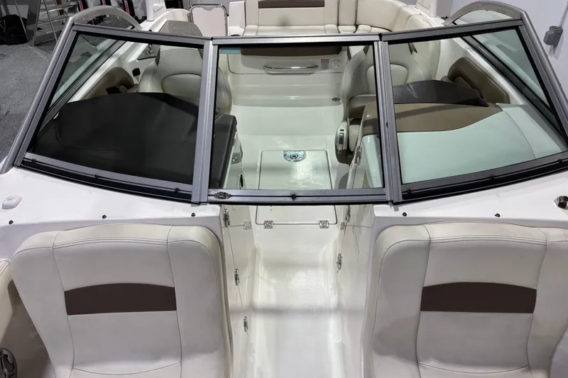 Slide: The Image of 2015 Chaparral 244 Sunesta boat interior with white and beige seating. - 11
