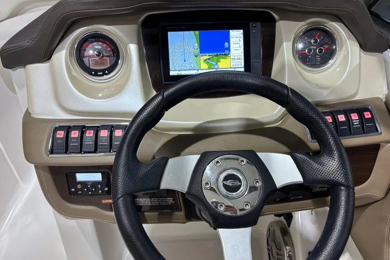 Slide: The Image of 2015 Chaparral 244 Sunesta dashboard with steering wheel and navigation display. - 12