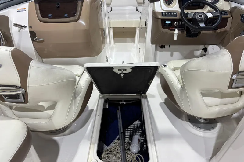 Slide: The Image of Interior of a 2015 Chaparral 244 Sunesta boat with open storage compartment. - 16