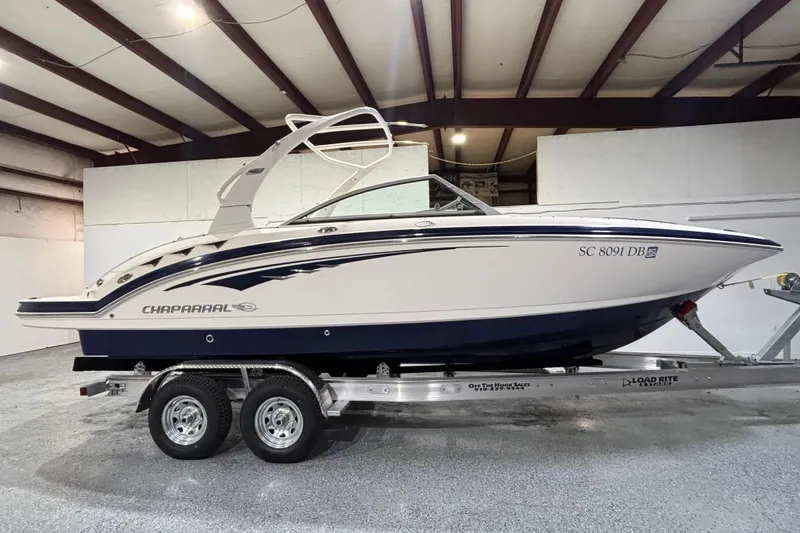 Slide: The Image of 2015 Chaparral 244 Sunesta boat on trailer in indoor storage facility. - 2