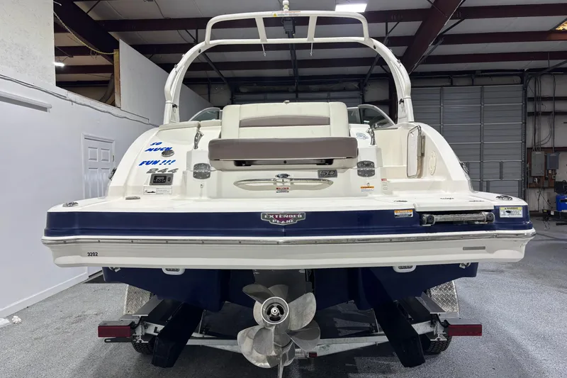 Slide: The Image of 2015 Chaparral 244 Sunesta boat in a garage, rear view showing propeller and swim platform. - 4