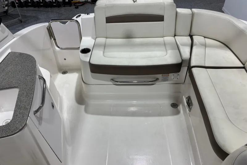 Slide: The Image of 2015 Chaparral 244 Sunesta boat interior with white seating and countertop. - 7