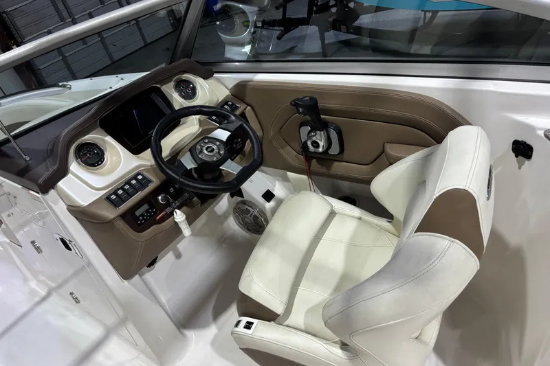 Slide: The Image of Interior cockpit of 2015 Chaparral 244 Sunesta boat with steering wheel and controls. - 8