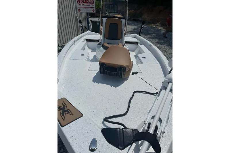 Slide: The Image of 2026 Xpress H20B Bay boat with tan seating and white deck. - 10