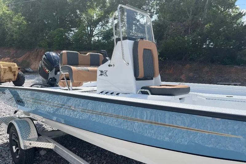 Slide: The Image of 2026 Xpress H20B Bay boat with sleek design, blue hull, and comfortable seating. - 6
