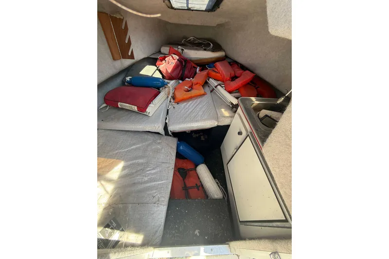 Slide: The Image of Interior of 1990 Bayliner 2302 Trophy Walkaround with life jackets and cushions. - 5