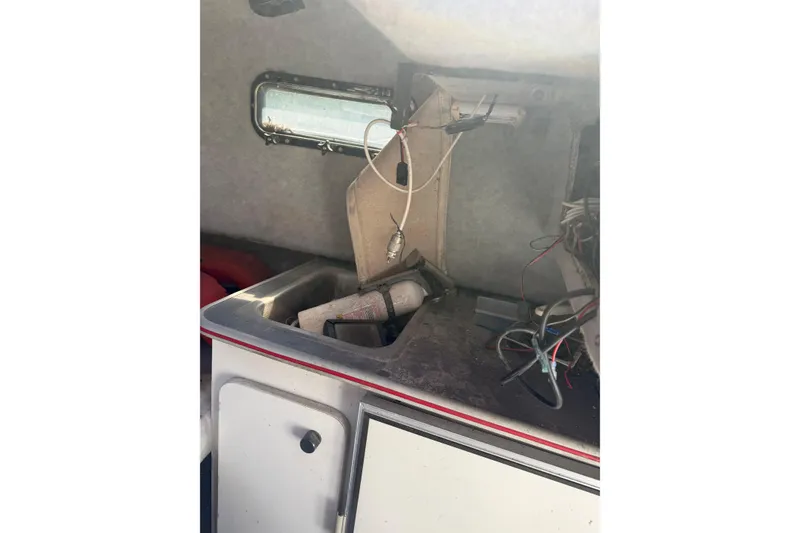 Slide: The Image of Interior of a 1990 Bayliner 2302 Trophy Walkaround boat showing cabin details and wiring. - 6