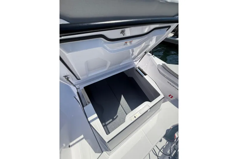 Slide: The Image of Open storage compartment on 2025 Axopar 29 XC Cross Cabin boat. - 10