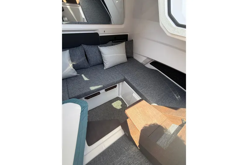 Slide: The Image of 2025 Axopar 29 XC Cross Cabin interior with cozy seating and modern design. - 11