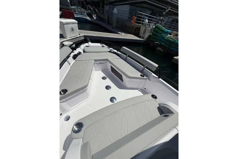 Slide: The Image of 2025 Axopar 29 XC Cross Cabin boat with spacious seating at the dock. - 12