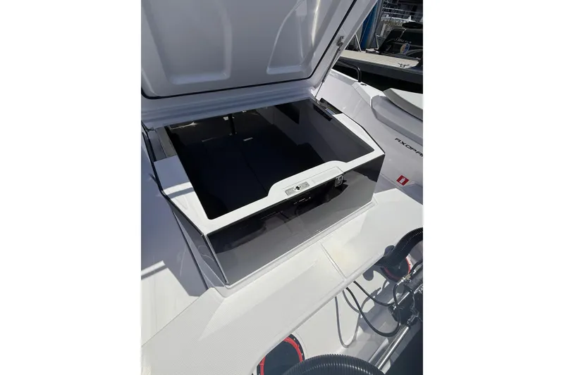 Slide: The Image of Open storage compartment on 2025 Axopar 29 XC Cross Cabin boat deck. - 14
