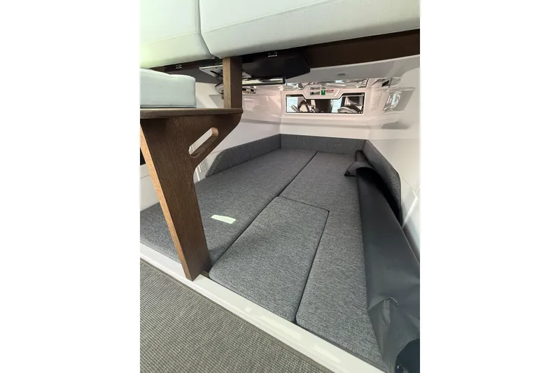 Slide: The Image of 2025 Axopar 29 XC Cross Cabin interior with modern seating and wooden accents. - 20
