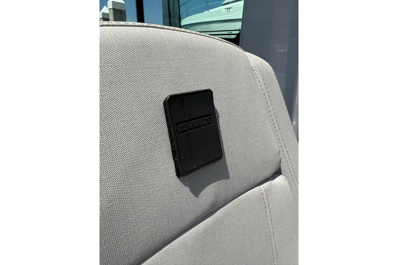 Slide: The Image of 2025 Axopar 29 XC Cross Cabin seat detail with logo patch. - 24