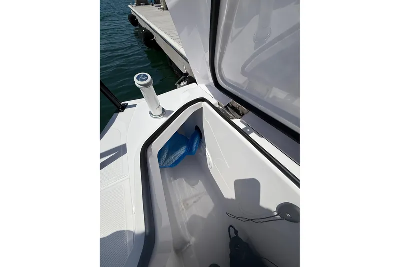 Slide: The Image of 2025 Axopar 29 XC Cross Cabin storage compartment near dock. - 28