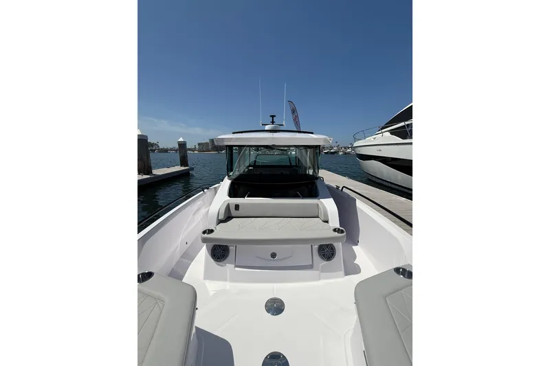 Slide: The Image of 2025 Axopar 29 XC Cross Cabin boat docked at marina under clear blue sky. - 9