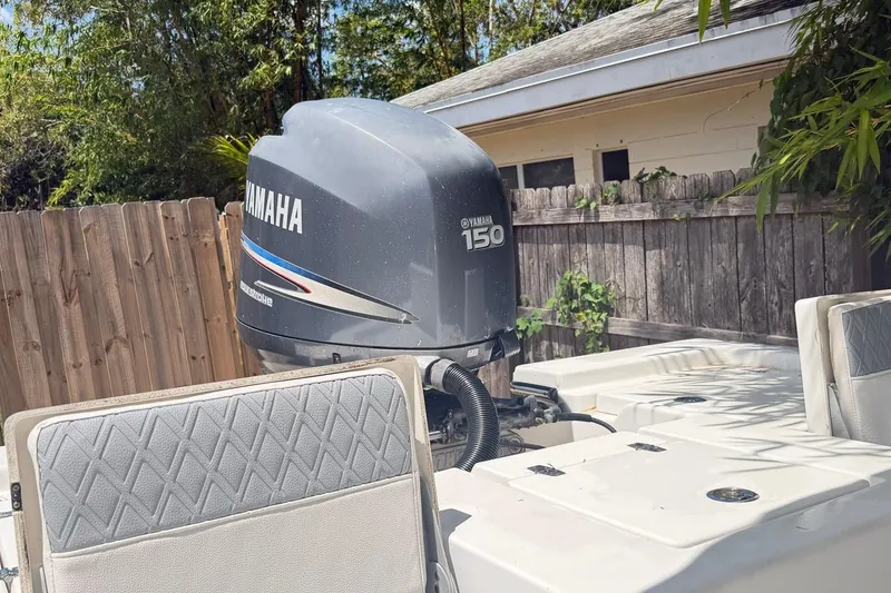 Slide: The Image of 2012 Pathfinder 2200 T boat with Yamaha 150 outboard motor in backyard setting. - 10