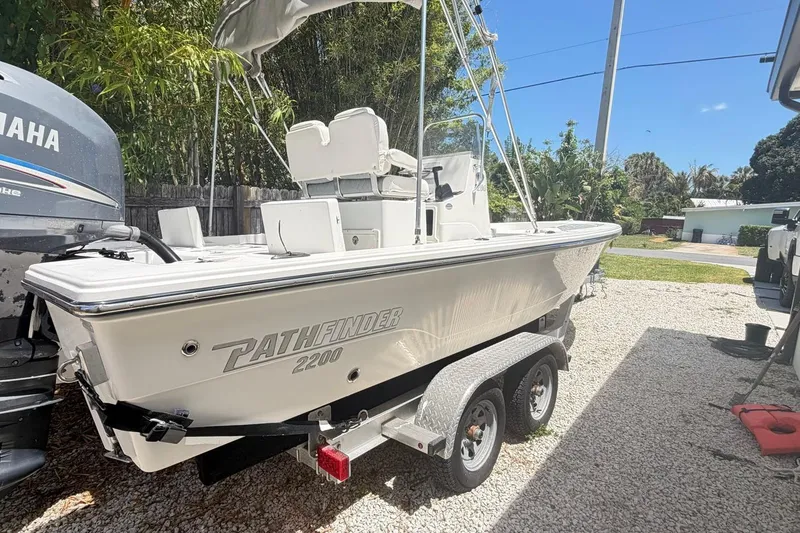 Slide: The Image of 2012 Pathfinder 2200 T boat on trailer, parked outdoors with Yamaha engine. - 11