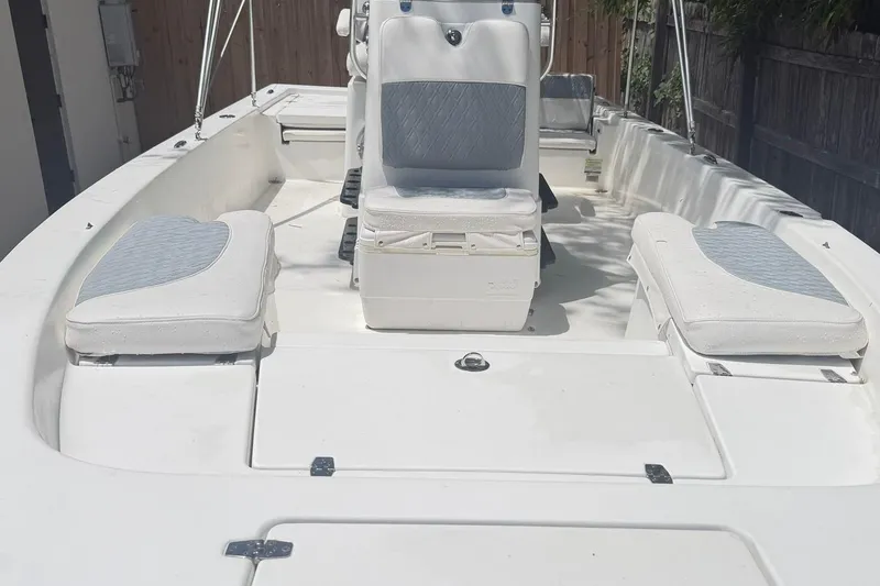 Slide: The Image of 2012 Pathfinder 2200 T boat interior with cushioned seating and storage compartments. - 4
