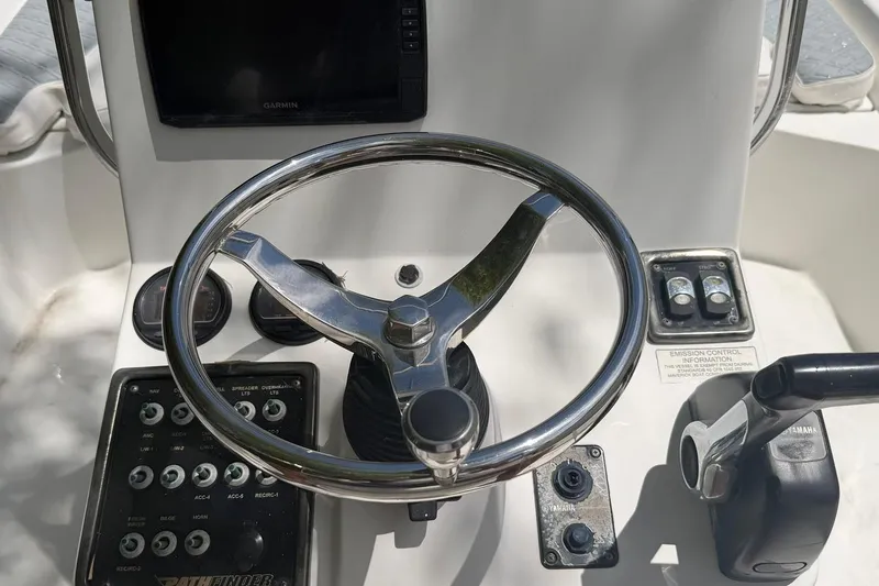 Slide: The Image of Steering console of a 2012 Pathfinder 2200 T boat with Garmin display and controls. - 7
