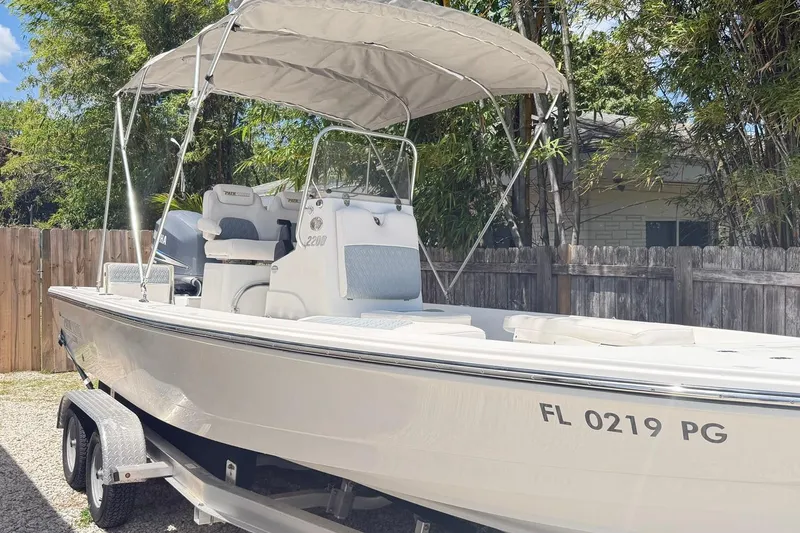 Slide: The Image of 2012 Pathfinder 2200 T boat with canopy on trailer, parked outdoors. - 9