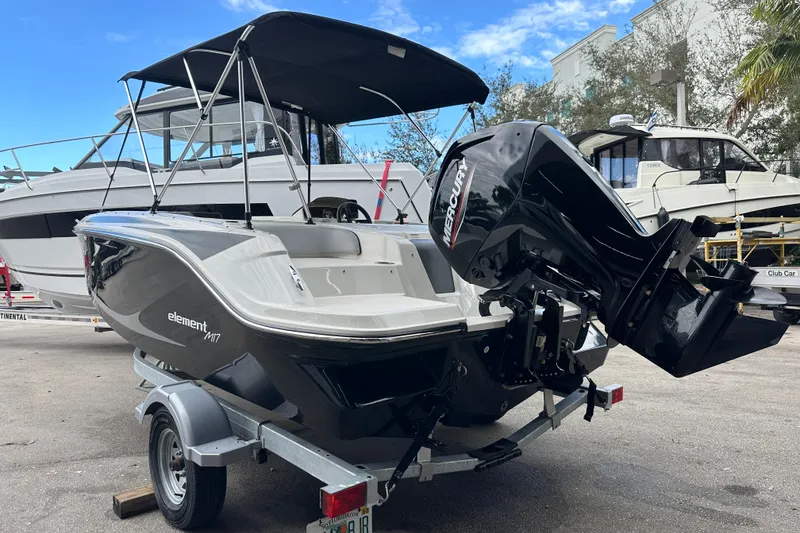 The Image of 2023 Bayliner M17 boat with Mercury engine on trailer, outdoor display. - 0
